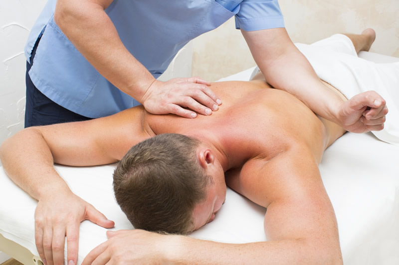 Massage therapist giving patient